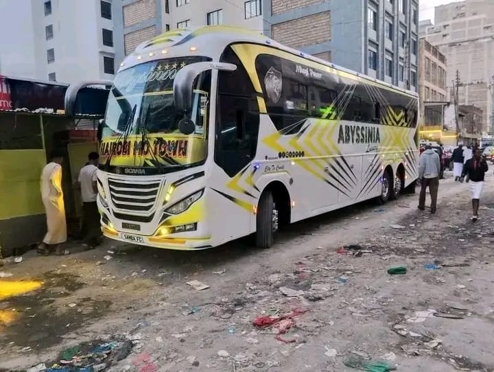 Abyssinia Luxury Coach bus boarding passengers at night in Nairobi